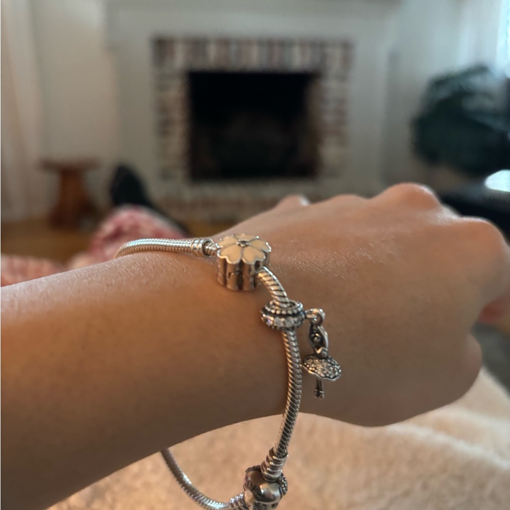 Pandora Moments Sparkling Heart Clasp Snake Chain Bracelet with two charms.